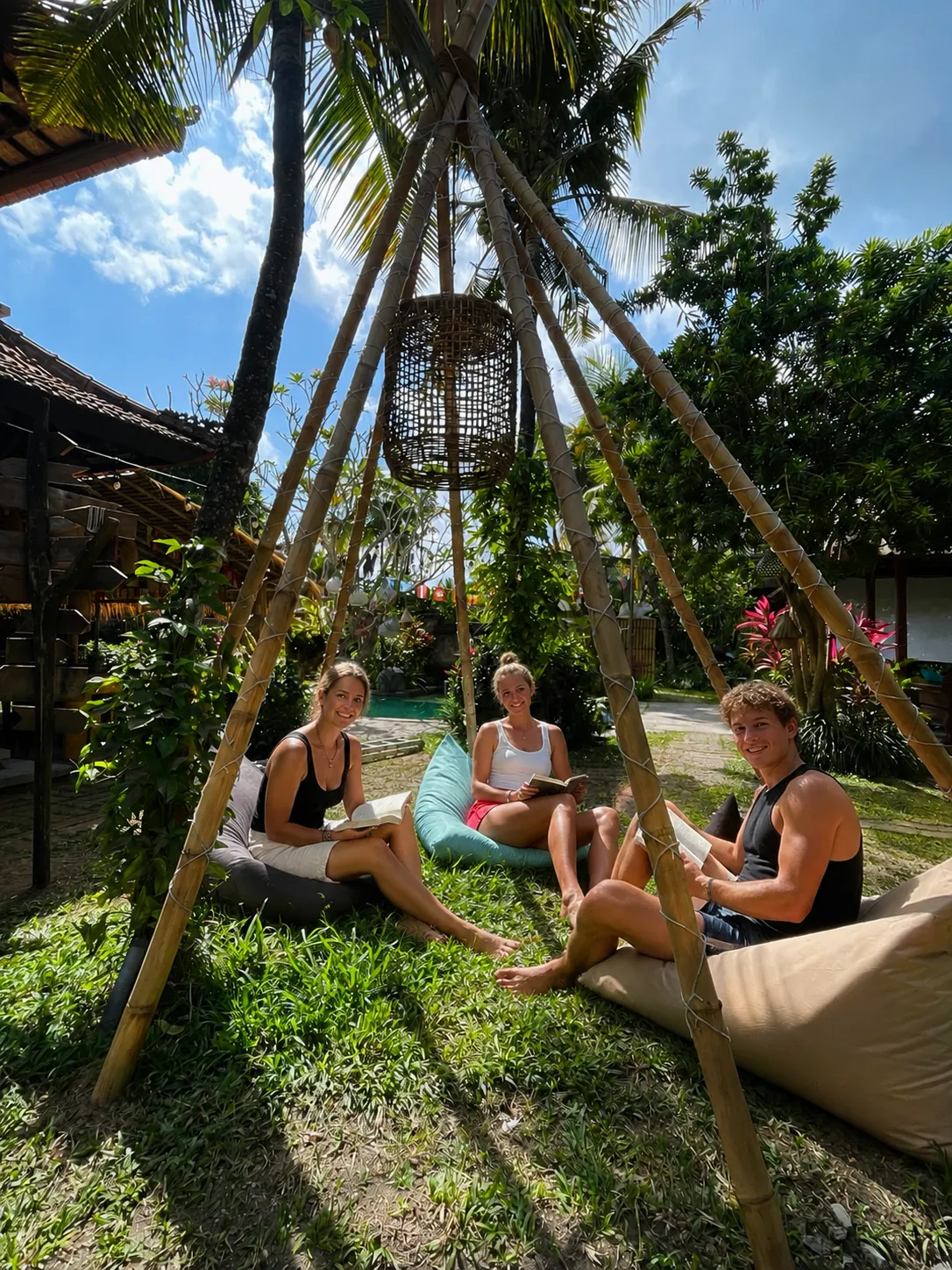 Guests reading on beanbags on the grass